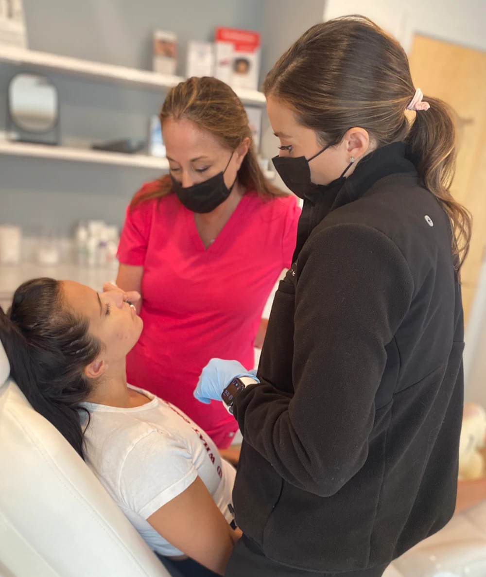 Dr. Margo Weishar and her assistant examine a patient