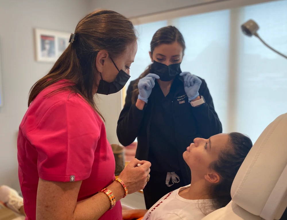 Dr. Margot Weishaar consults with a patient before treatment