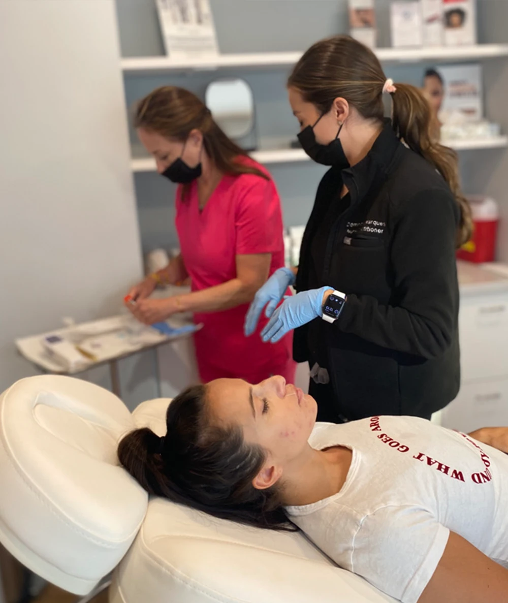 Dr. Margo Weishar and her assistant at procedure with patient