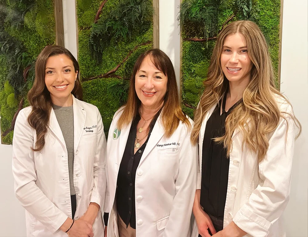 Pediatric dermatologists: Team of female doctors smiling in medical clinic setting